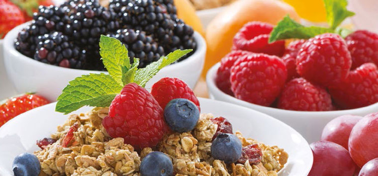 A selection of berries, granola and greek yogurt.