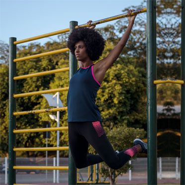 A woman exercising on a set of bars